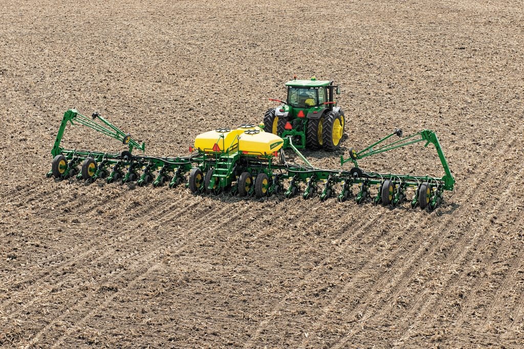 Farm equipment operating in an Iowa field, representing modern farming practices and land productivity