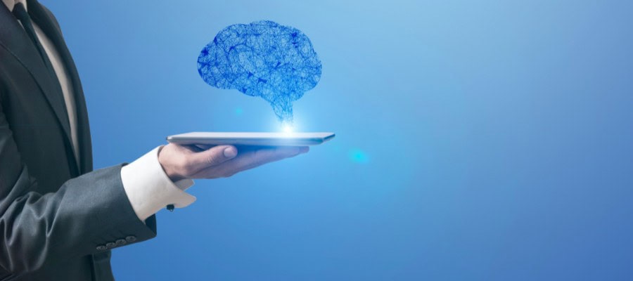 Business professional holding a tablet displaying a glowing AI brain, representing ChatGPT technology in real estate marketing