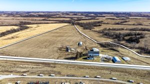 Aerial view of Ringgold County, IA acreage for sale—Tract 3 (34± acres) with the boundary outlined in white, featuring a 3-bedroom country home, multiple outbuildings, and open ground.