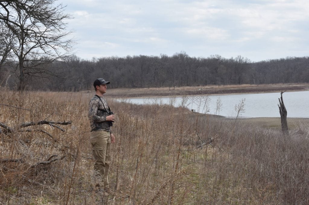 hunter scouting iowa hunting land near water and timber habitat