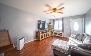 Living room inside Sullivan Missouri home for sale with hardwood floors and natural light