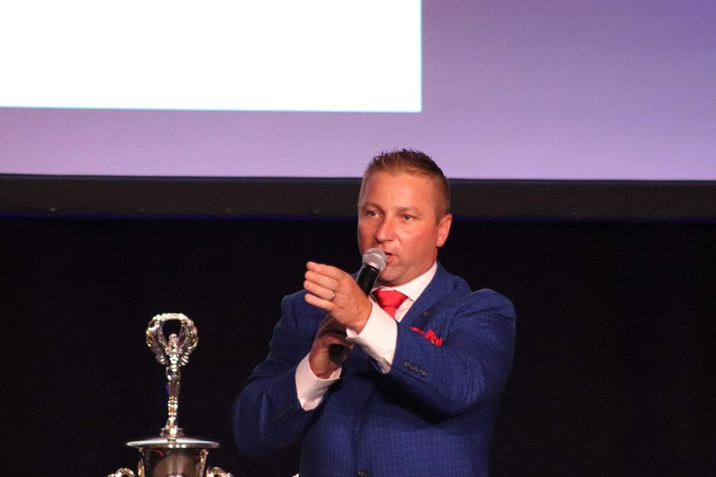 farmland auctioneer speaking at live land auction event with microphone