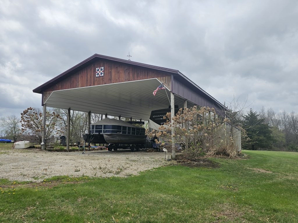 Lake Thunderhead lot for sale with large camper cover structure and gravel parking in Putnam County Missouri