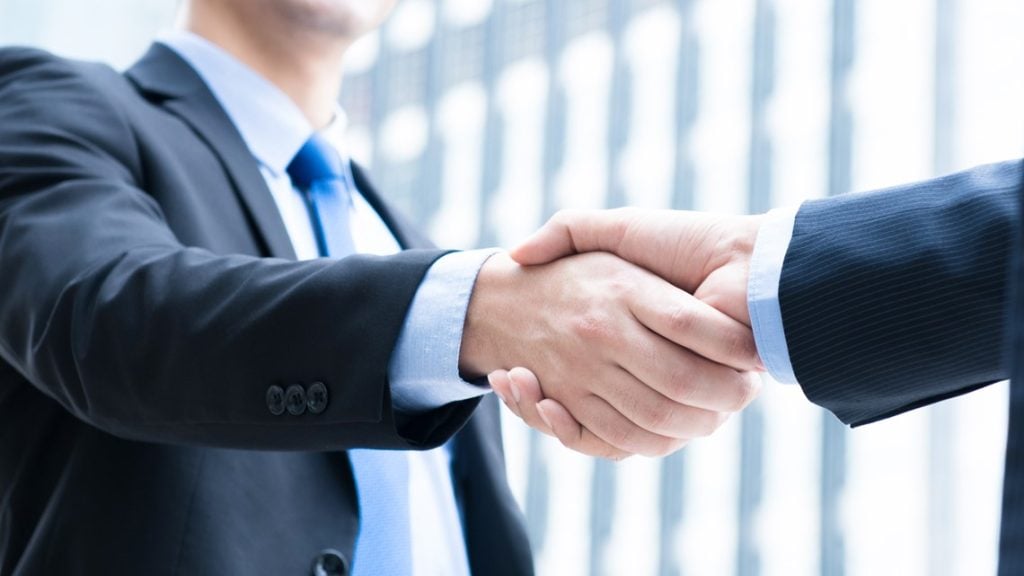 Land sale negotiation agreement between buyer and seller handshake