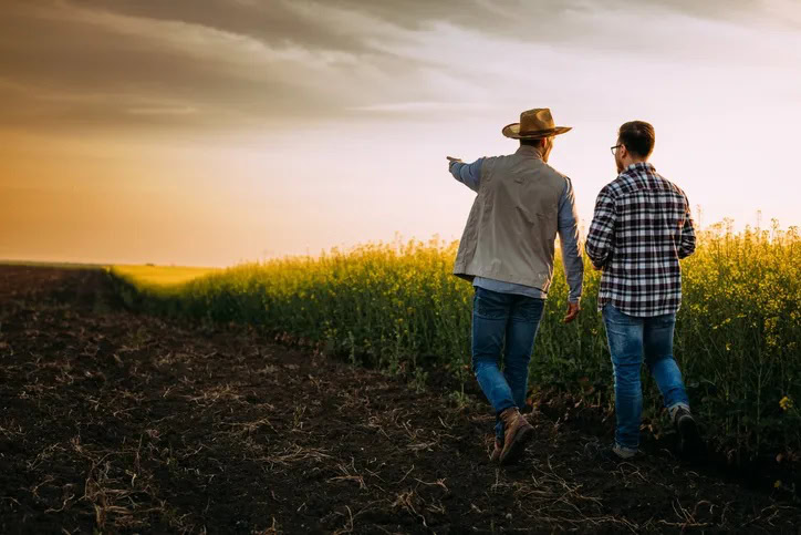 landowner discussing property with real estate agent farmland sale decision