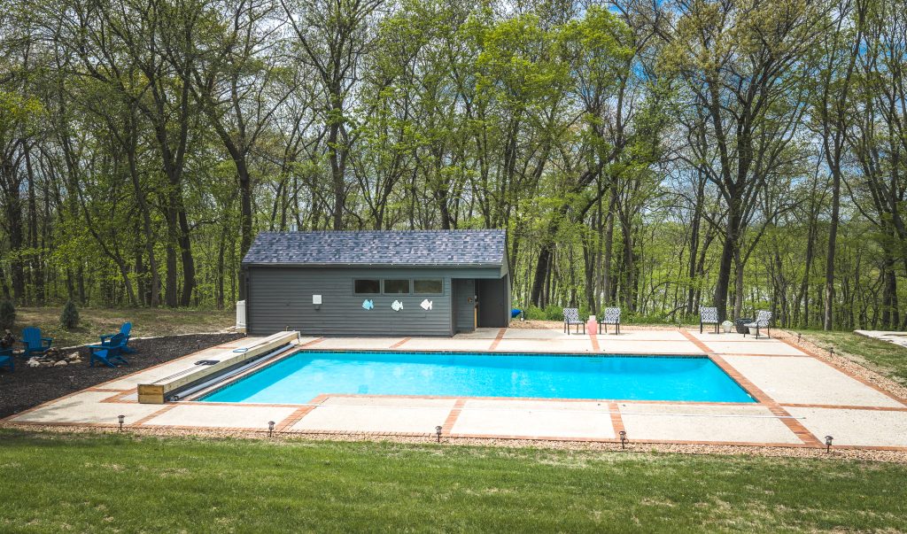 In-ground pool and pool house at luxury acreage home for sale in West Des Moines Iowa