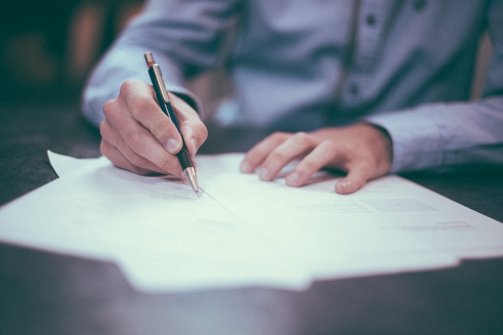 Signing farmland sale documents during the contract to closing process
