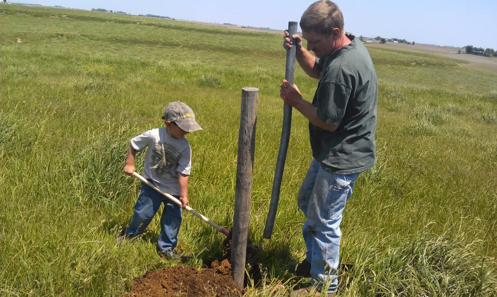 Multi-generational Iowa family working together on farmland