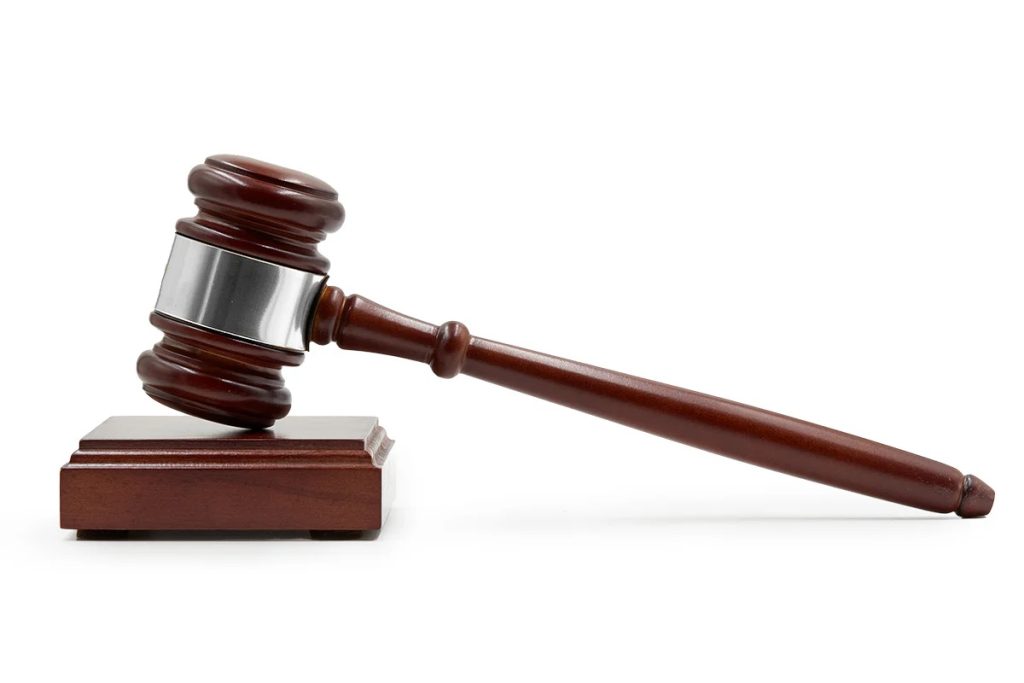 Auction gavel representing online vs live land auctions for farmland sales