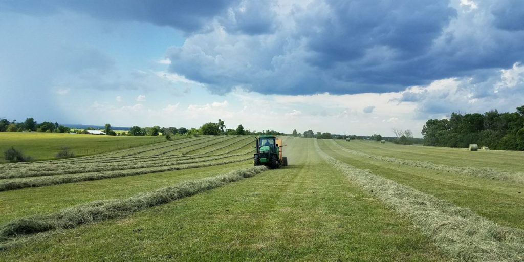 Missouri agricultural land with productive hay field and farm equipment
