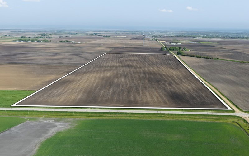 Aerial view of 76.2-acre Boone County Iowa farmland for sale near Kelley, featuring highly productive tillable acres with an 86.4 CSR2 soil rating.