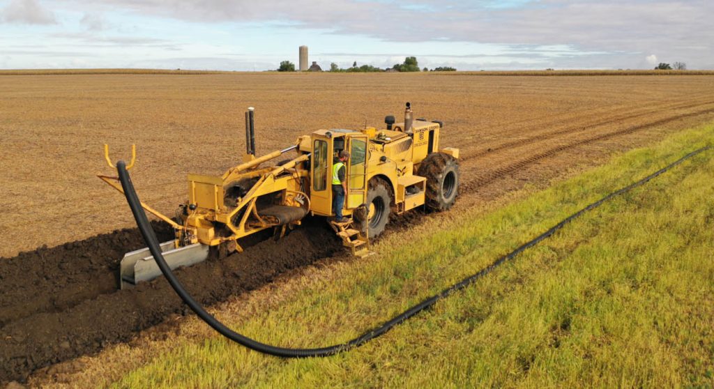 Drain tile installation on Midwestern farmland improves drainage, soil productivity, and overall property value.