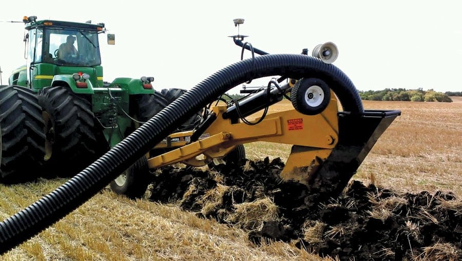 Tile drainage installation on a Midwest farm using specialized trenching equipment