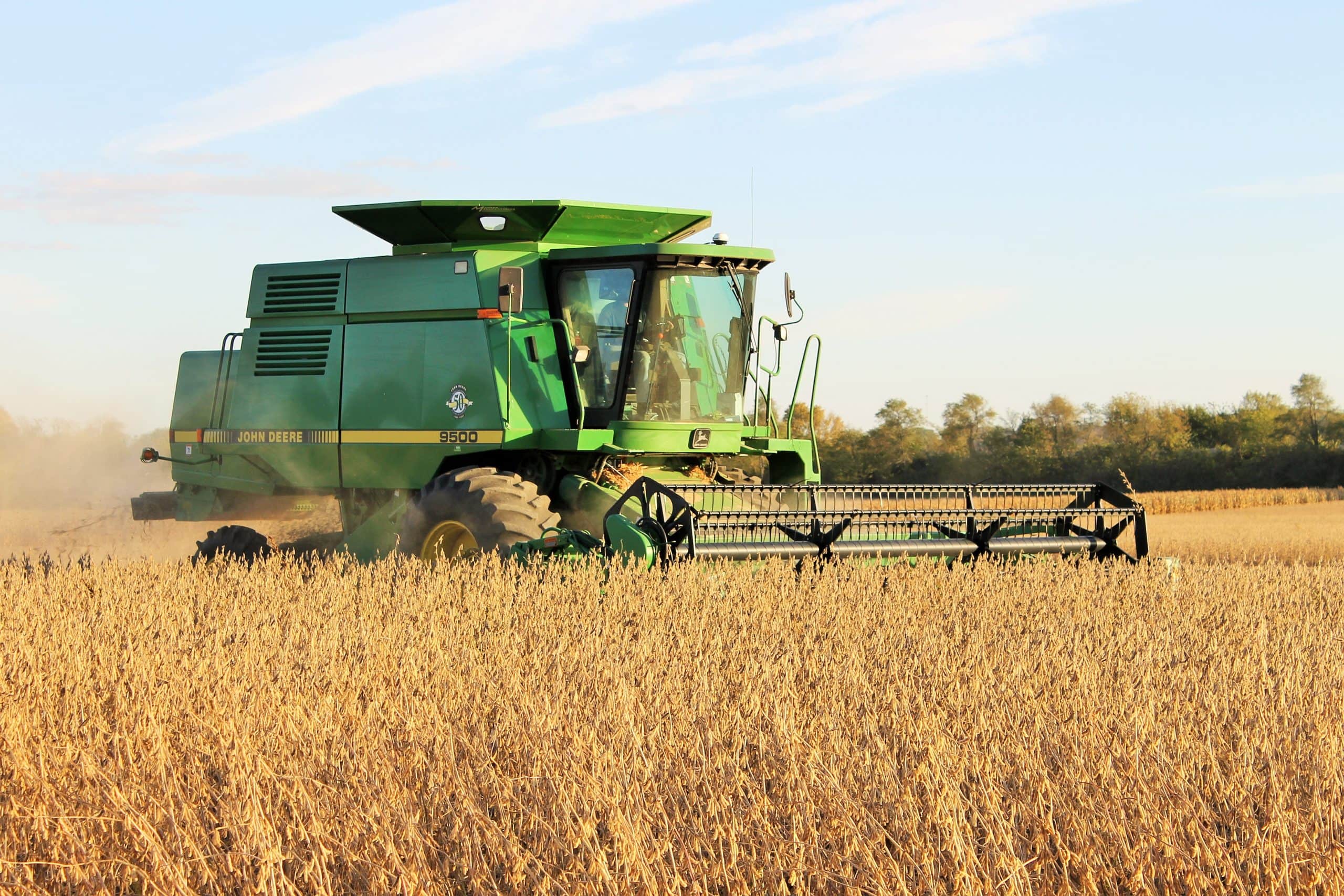 High-yield farm harvesting soybeans with modern agricultural equipment