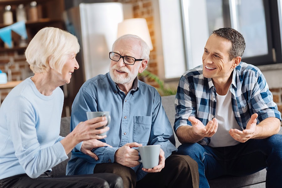 Adult child discussing farmland estate planning with aging parents